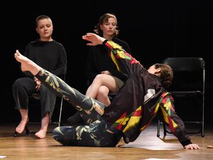 two dancers on stage, two students observe
