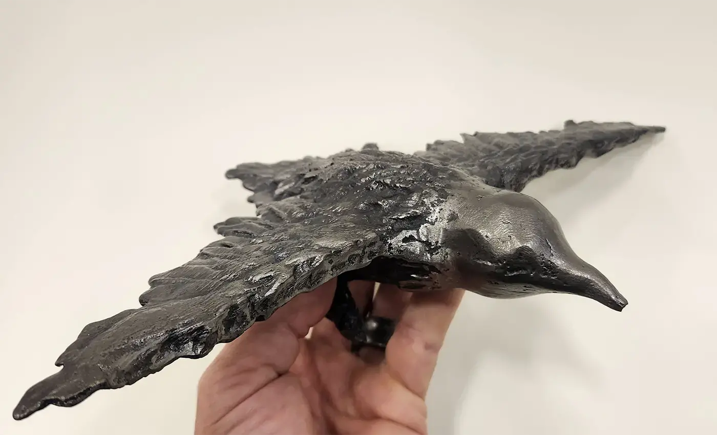 Iron sculpture of a bird flying