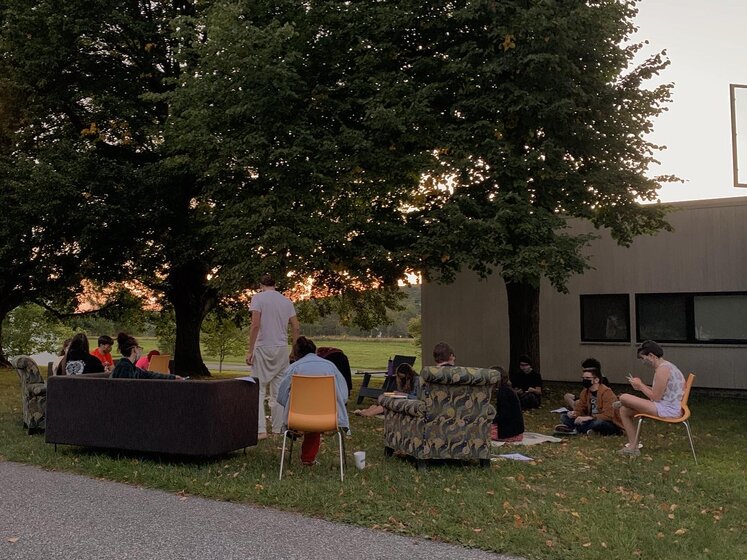 Image of students with living room outside