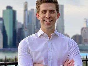 Image of Matthew Clarke in front of cityscape