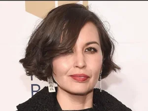 headshot of woman with short brown hair and lipstick