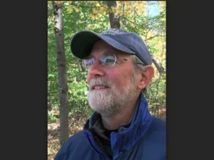 bearded man with baseball cap in a forest