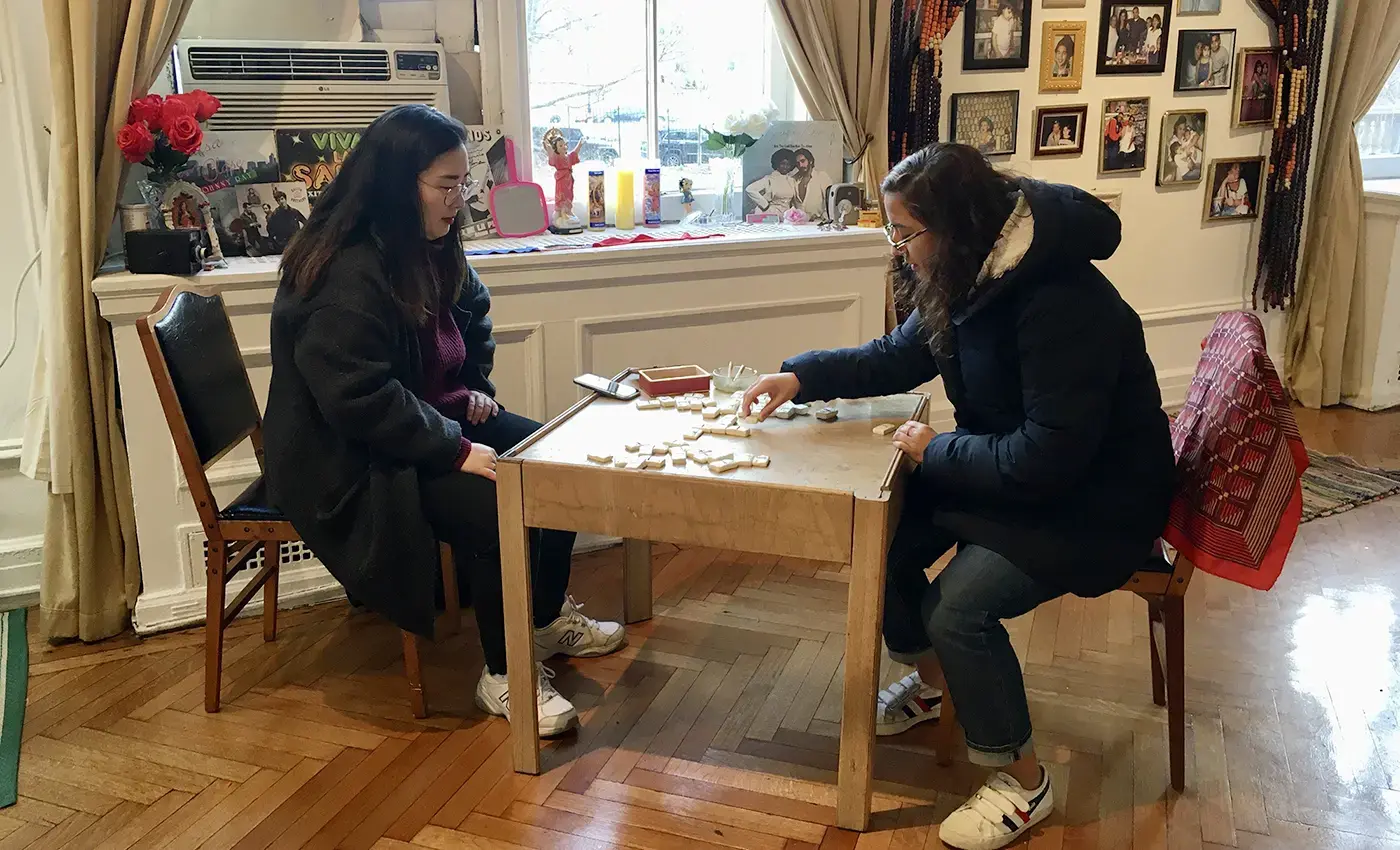 Students playing dominoes at exhibition