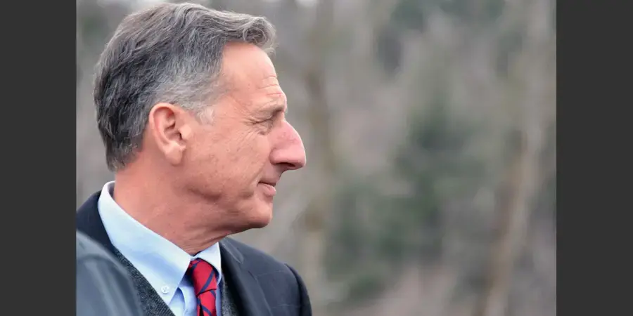 side profile of the head of a man (Peter Shumlin) in a suit with blurred grey background