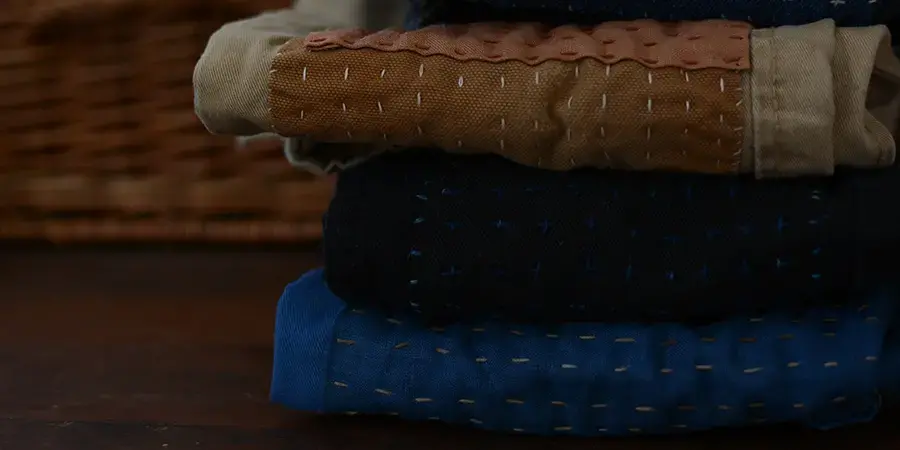 a stack of mended clothes on a table