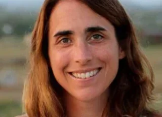 Ariel Redden headshot against country backdrop