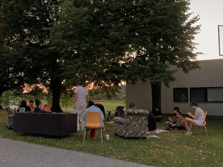 Image of students with living room outside